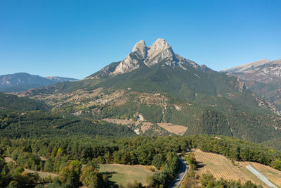 Scenic view of mountains against clear blue sky