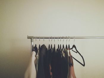Clothes hanging on rack against wall