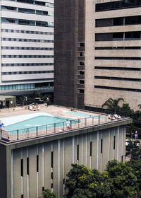 Swimming pool against building in city