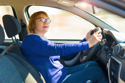 Woman sitting in car