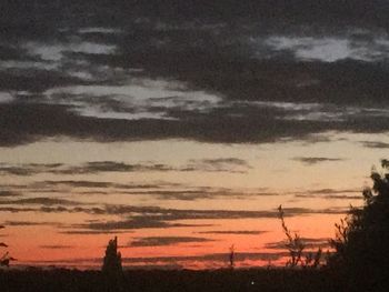 Scenic view of silhouette landscape against sky at sunset