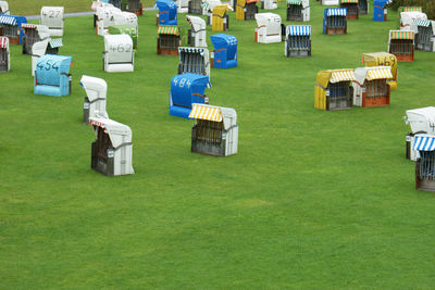 High angle view of chairs on grassy field