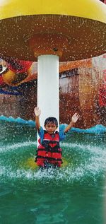 Full length of boy enjoying in water