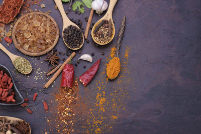 Top view of various spices, chili garlic salt and pepper placed on the table