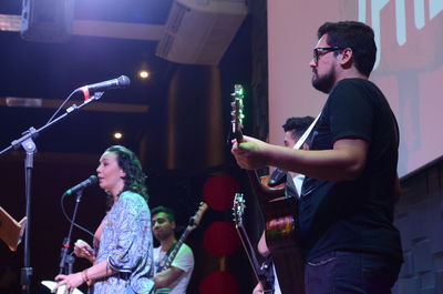 Young couple standing at music concert