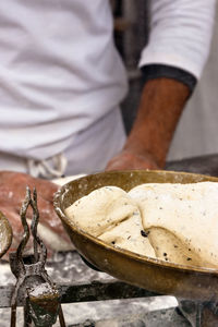 Midsection of man preparing food