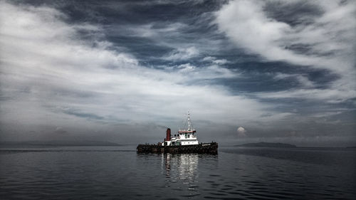 Ship sailing in sea against sky