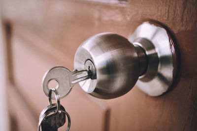 Close-up of key on doorknob