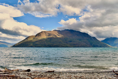 Scenic view of sea and mountains against sky