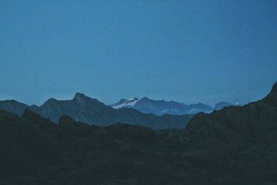 Scenic view of mountains against clear blue sky