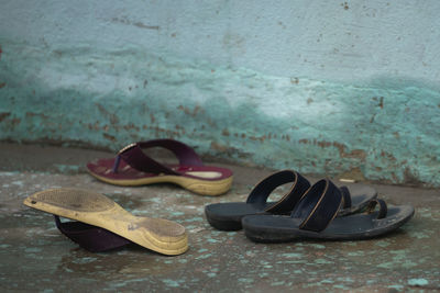 Close-up of abandoned shoes on wall