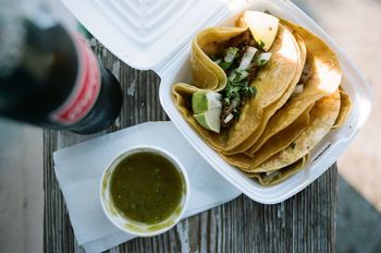 High angle view of tacos with cola served on seat