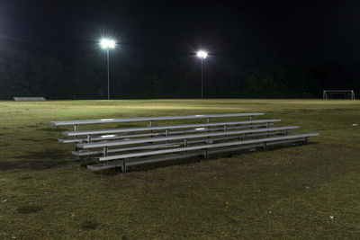 Empty seats in grass at night