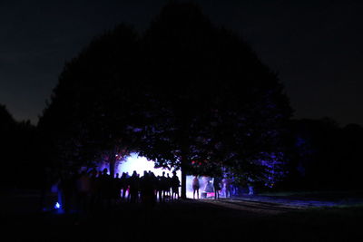 Silhouette people standing by tree