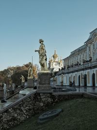 Statue in city against clear sky