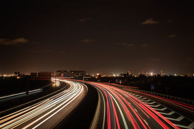 High angle view of light trails on road at night