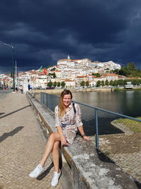 Full length of woman sitting outdoors