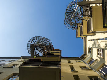 Low angle view of balconies and circular stairways against clear sky, berlin