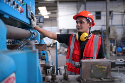 Portrait of male worker standing in the heavy industry manufacturing factory.