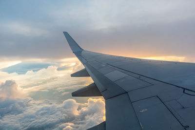 Airplane flying over clouds in sky