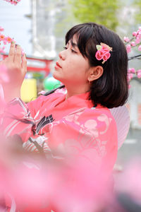 Portrait of young woman holding flower