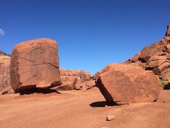 Rock formations in desert against clear blue sky