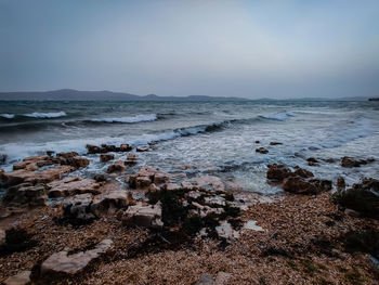 Scenic view of sea against sky, during heavy winds.