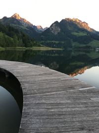 Scenic view of lake and mountains against clear sky