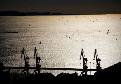 High angle view of silhouette ship on sea against sky