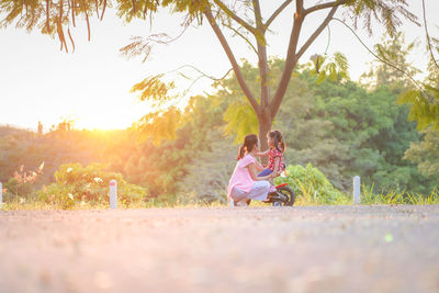 Rear view of people sitting in park