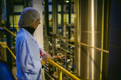 Close-up of researcher standing by railing