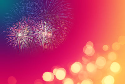 Low angle view of firework display at night