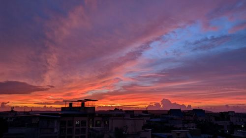 Silhouette buildings against sky during sunset