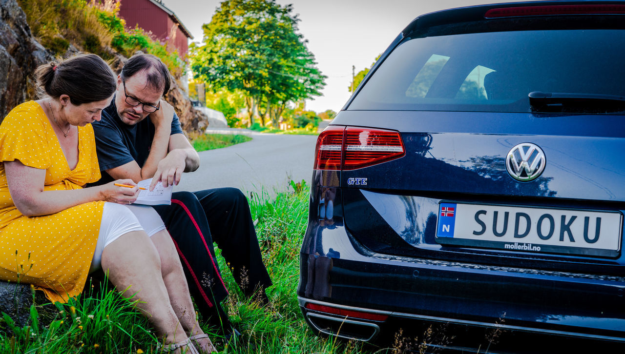 WOMAN SITTING IN A CAR ON ROAD