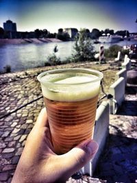 Close-up of hand holding beer glass