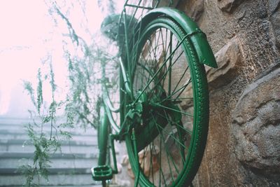 Close-up of bicycle wheel against wall