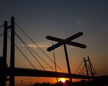 Low angle view of silhouette built structure against sky