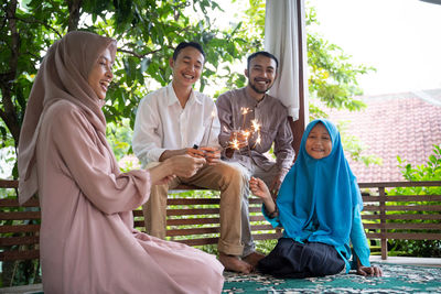 Portrait of smiling couple sitting at home