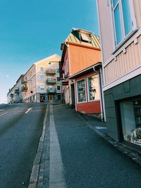 Empty street amidst buildings against sky