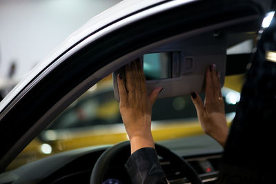 Close-up of woman in car seen through window