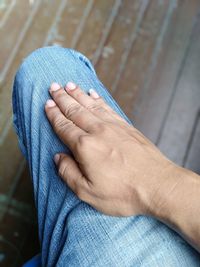 Close-up of man hand against blue wall