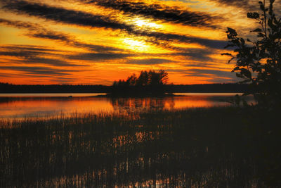 Scenic view of lake against romantic sky at sunset