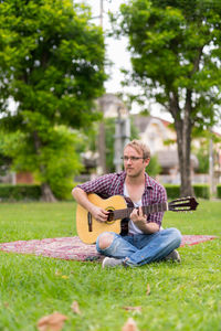 Man playing guitar in park