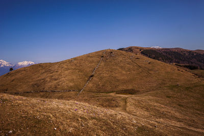 Scenic view of mountains against clear blue sky