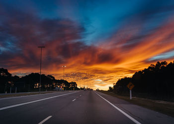 Road against dramatic sky during sunset