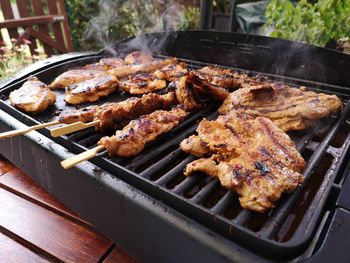 High angle view of meat on barbecue grill