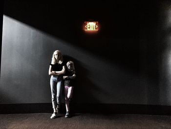 People standing in illuminated room