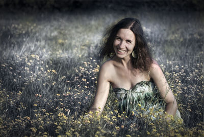 Portrait of smiling young woman on field