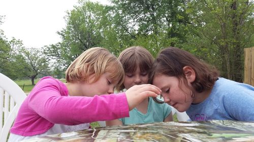 Siblings and daughter against trees