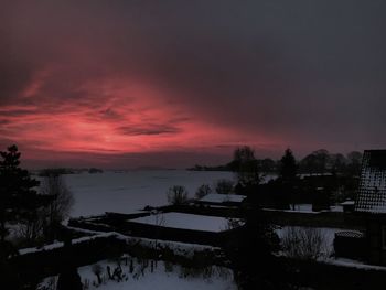 Scenic view of frozen lake against orange sky